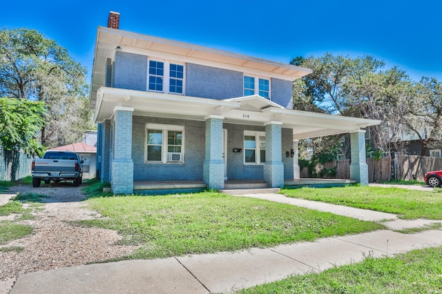 view of front of property with covered porch and a front lawn