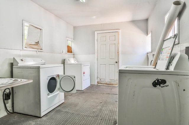 laundry area with washing machine and dryer and light colored carpet