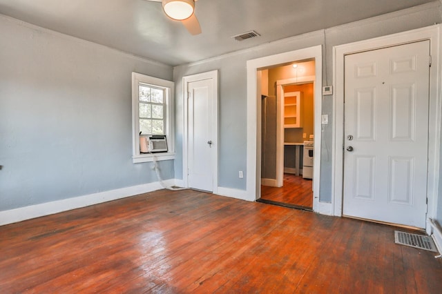 unfurnished bedroom featuring dark hardwood / wood-style flooring, cooling unit, and ceiling fan