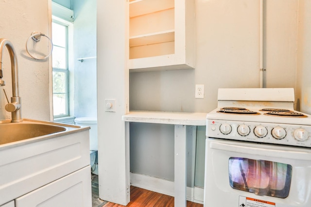 kitchen with white cabinets, wood-type flooring, sink, and white range with electric stovetop