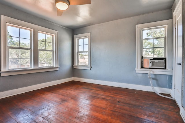 empty room with dark hardwood / wood-style floors, cooling unit, and ceiling fan