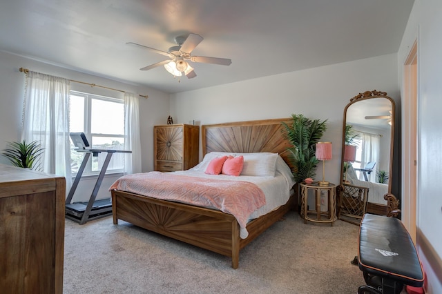 carpeted bedroom featuring ceiling fan and multiple windows