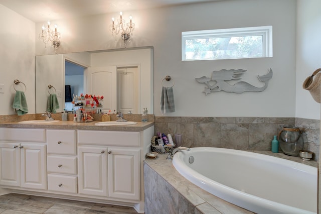full bathroom with a bath, a sink, and double vanity