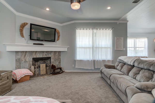 living area with crown molding, a tile fireplace, carpet, visible vents, and recessed lighting