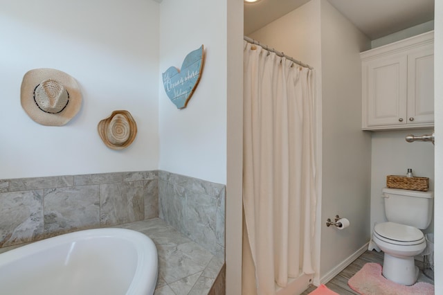 bathroom with a bath, toilet, and wood finished floors