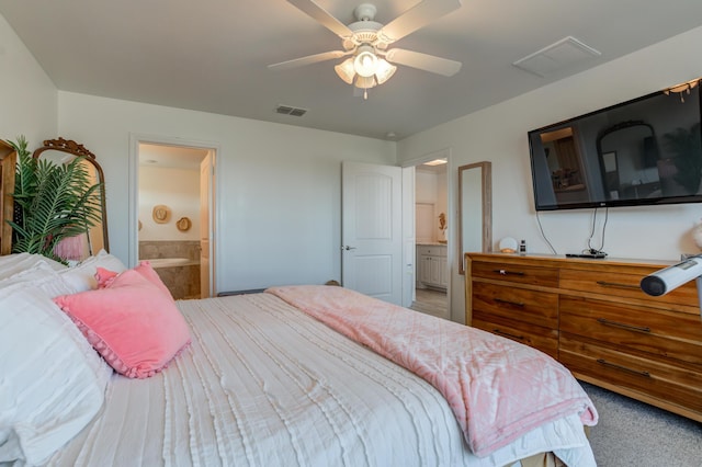 bedroom with visible vents, a ceiling fan, ensuite bath, and light colored carpet
