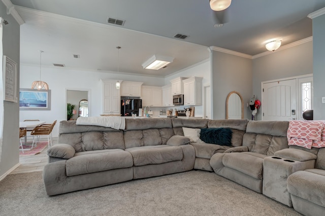 living room featuring baseboards, crown molding, and visible vents