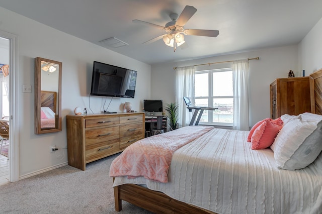 bedroom featuring ceiling fan, light carpet, and baseboards