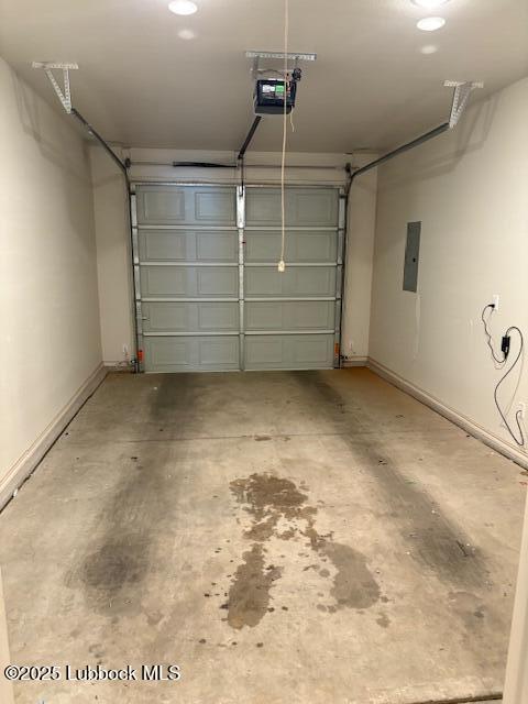2612 136th St, Lubbock, TX 79423 - garage with a garage door opener, electric panel, and baseboards