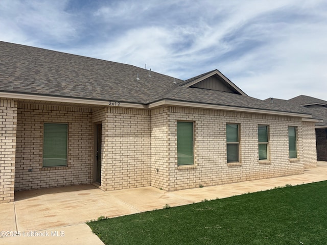 2612 136th St, Lubbock, TX 79423 - back of house featuring brick siding, a shingled roof, and a patio area