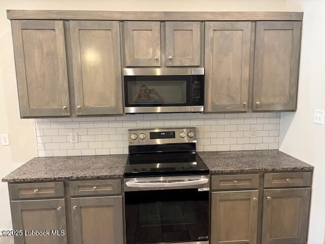 2612 136th St, Lubbock, TX 79423 - kitchen featuring stainless steel appliances, decorative backsplash, and dark stone countertops