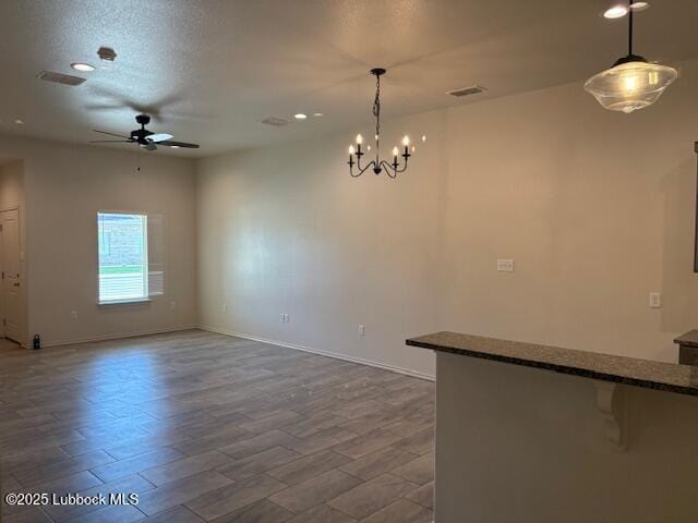 2612 136th St, Lubbock, TX 79423 - empty room with a ceiling fan, a chandelier, baseboards, recessed lighting, and wood finished floors