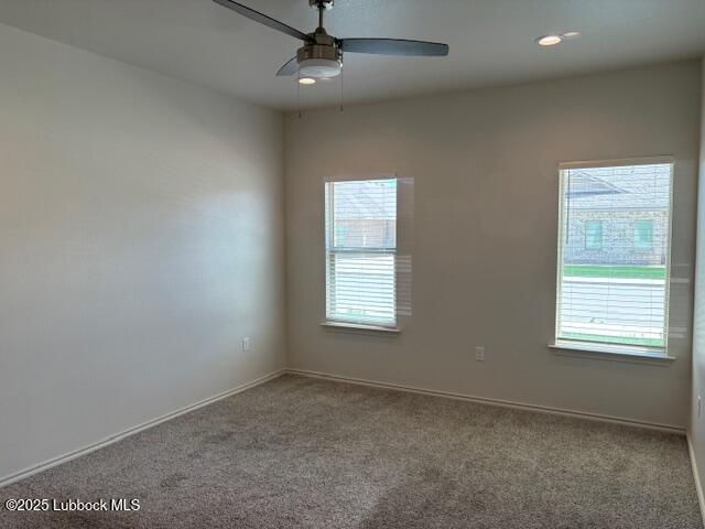 2612 136th St, Lubbock, TX 79423 - empty room with healthy amount of natural light, carpet floors, a ceiling fan, and baseboards