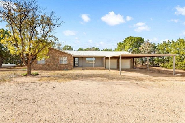 view of front of property with a carport and a garage