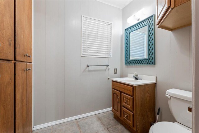 bathroom featuring vanity, tile patterned flooring, and toilet