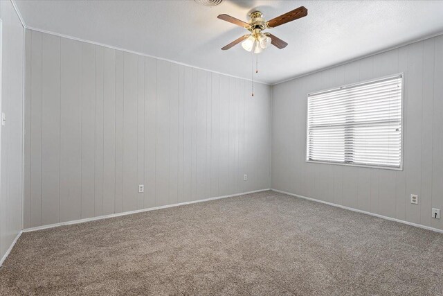 carpeted spare room featuring a textured ceiling and ceiling fan