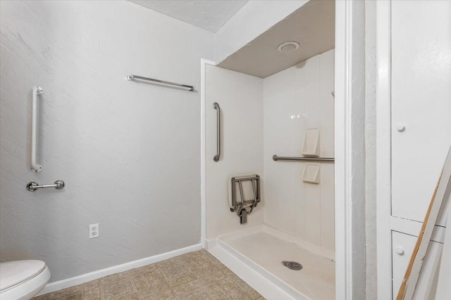 bathroom with walk in shower and toilet