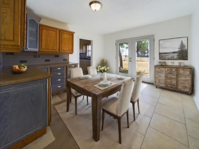 tiled dining area featuring french doors