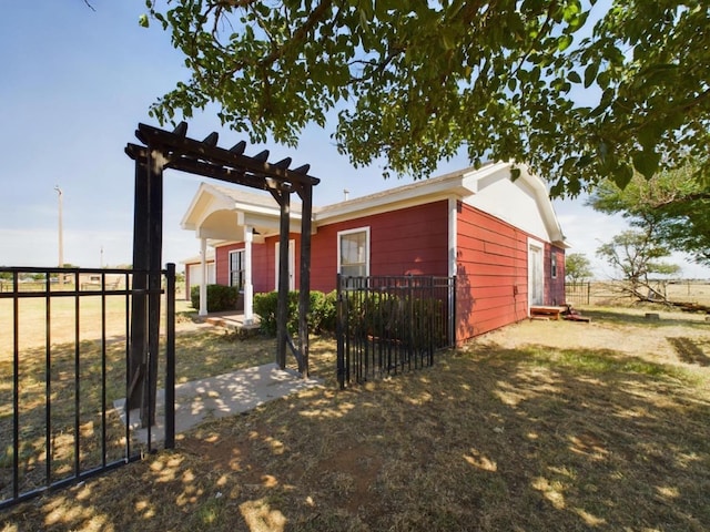 view of home's exterior featuring a pergola