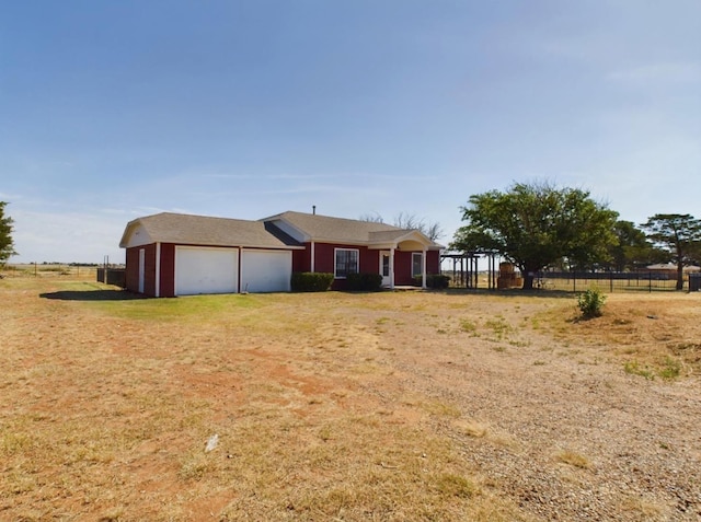 view of front of home with a rural view