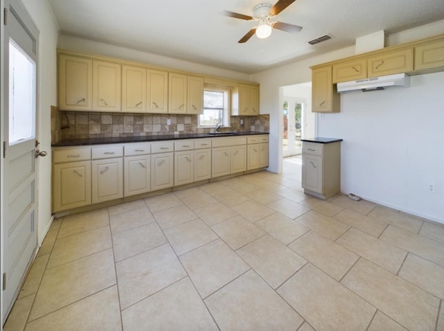 kitchen featuring sink, light tile patterned floors, ceiling fan, and decorative backsplash