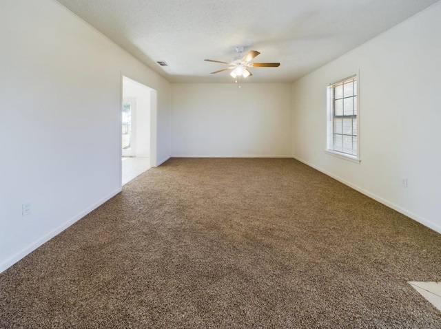 spare room with ceiling fan, carpet, and a textured ceiling