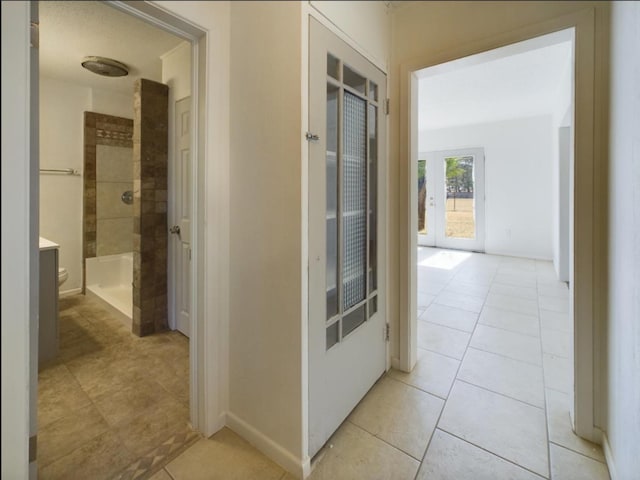 hall featuring light tile patterned flooring