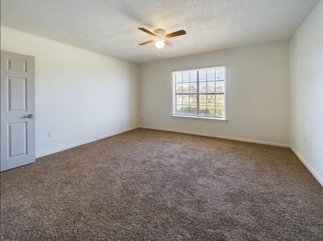 carpeted empty room featuring ceiling fan and a textured ceiling