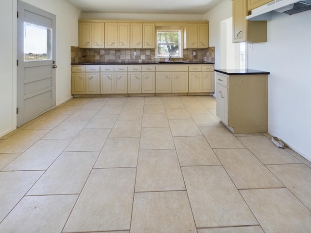 kitchen featuring light tile patterned flooring, sink, decorative backsplash, and light brown cabinets