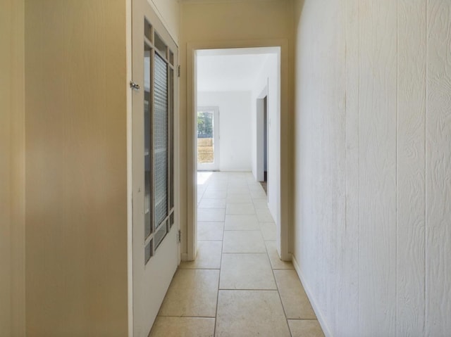 hall with light tile patterned floors