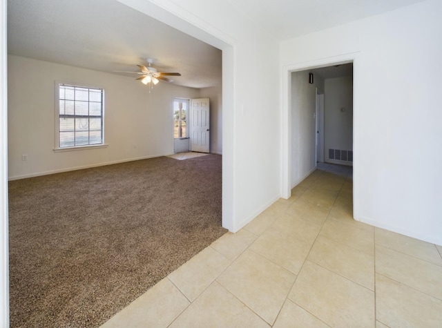 carpeted empty room featuring ceiling fan