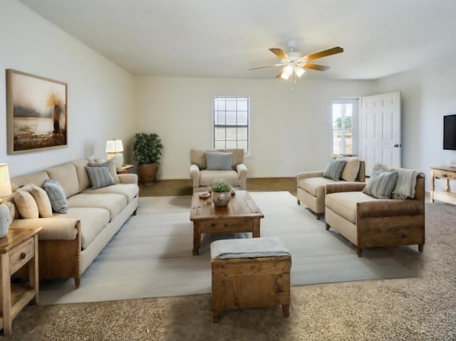 living room featuring ceiling fan, light colored carpet, and a healthy amount of sunlight