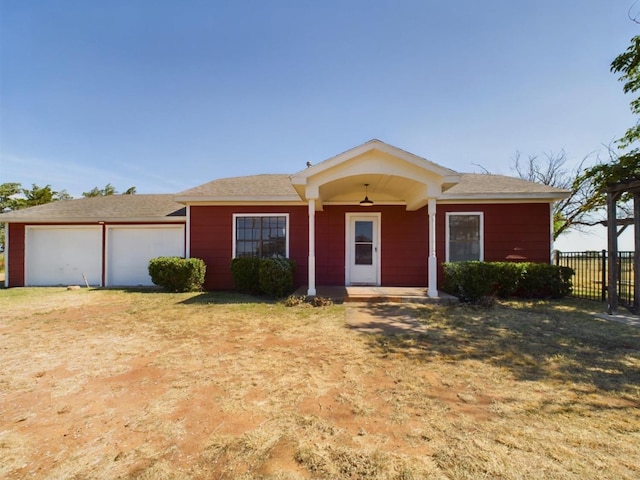 single story home featuring a garage and a front lawn