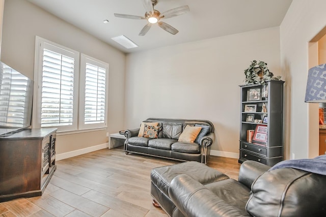 living room with ceiling fan and light hardwood / wood-style floors