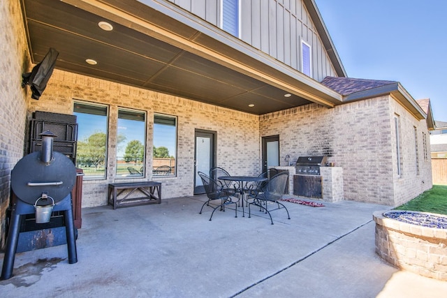 view of patio / terrace with exterior kitchen and a grill