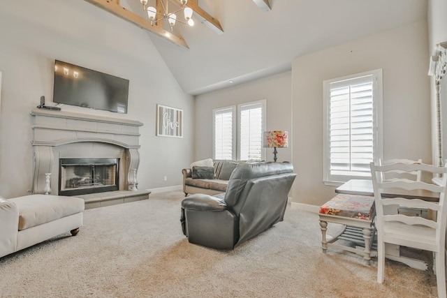 carpeted living room featuring high vaulted ceiling, a wealth of natural light, a tile fireplace, and beamed ceiling