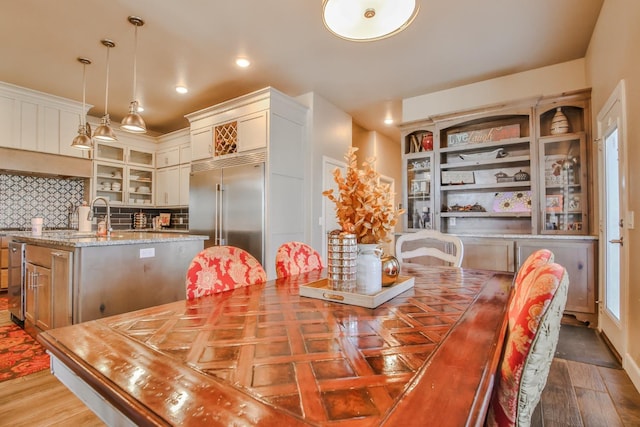 dining area featuring sink and hardwood / wood-style floors