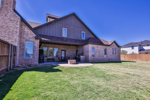 back of house featuring a patio area and a lawn