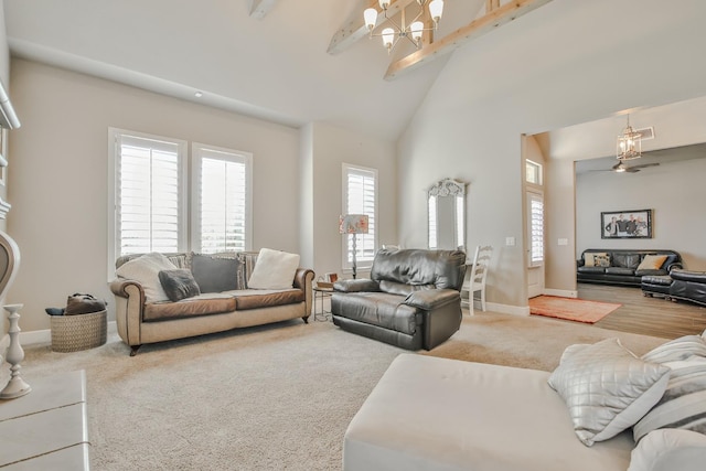 living room with plenty of natural light, high vaulted ceiling, beamed ceiling, and carpet