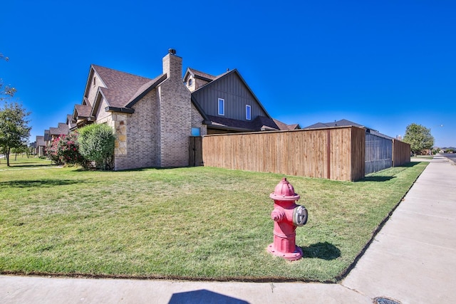 view of side of property featuring a yard