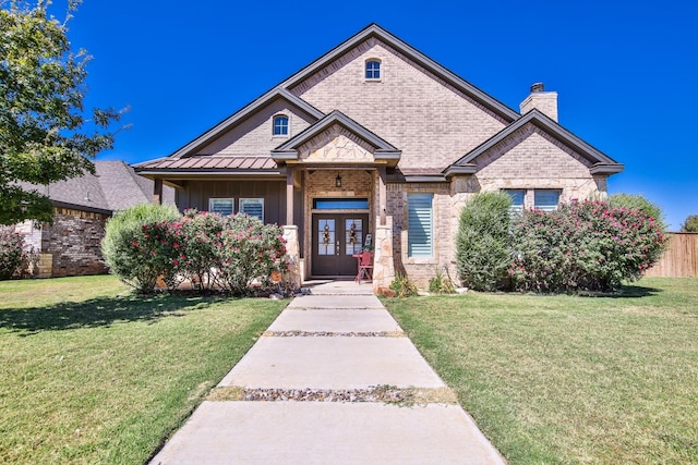 view of front of home with french doors and a front lawn