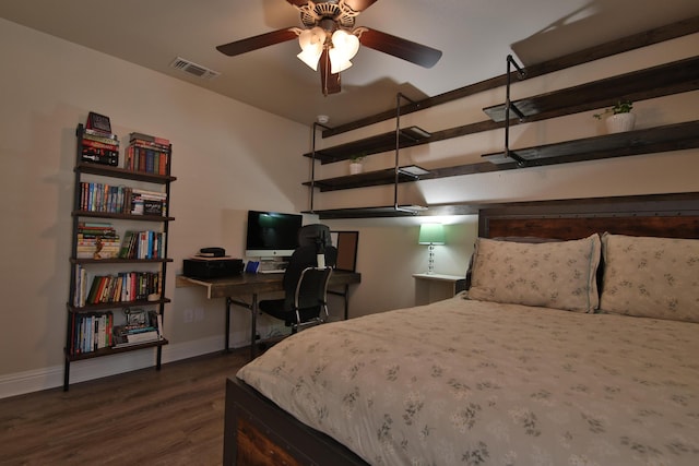 bedroom featuring dark wood finished floors, visible vents, a garage, and baseboards