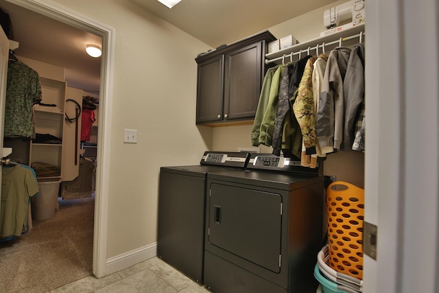 laundry area with light carpet, cabinet space, baseboards, and separate washer and dryer