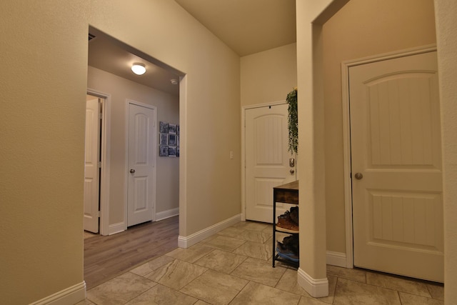 hallway featuring baseboards