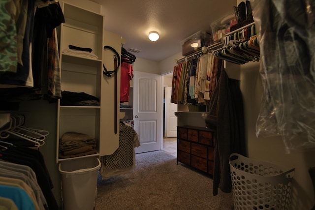 walk in closet with visible vents and carpet floors