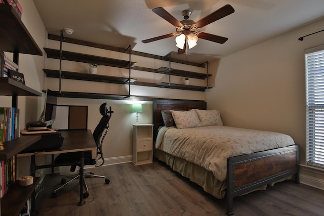 bedroom featuring baseboards and wood finished floors