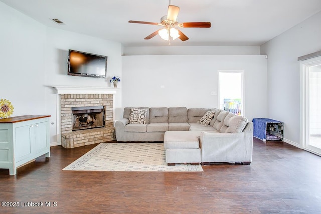 1308 Nottingham Ave, Wolfforth, TX 79382 - living area featuring a ceiling fan, dark wood-style floors, and a brick fireplace