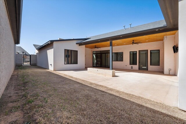 12001 Vicksburg Ave, Lubbock, TX 79424 - back of house with ceiling fan, a patio, a gate, and stucco siding
