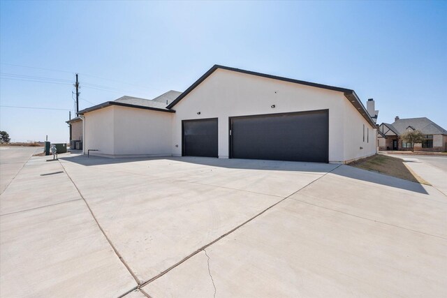 12001 Vicksburg Ave, Lubbock, TX 79424 - view of side of property featuring concrete driveway and stucco siding