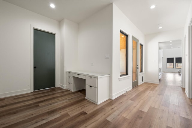 12001 Vicksburg Ave, Lubbock, TX 79424 - hallway featuring light wood-style flooring, a desk, recessed lighting, and baseboards